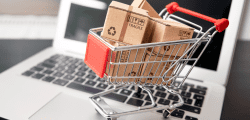 shopping trolley in front of a laptop to symbolise e-commerce and transactional website